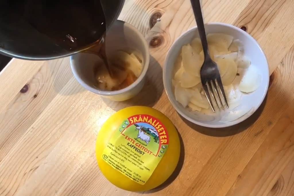 Coffee being poured over cheese shavings